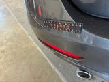a close up of a car ' s tail light with a sticker on it