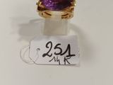 Gros plan sur une bague ornée d'une pierre violette