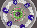 une assiette en verre décorée de fleurs, posée sur une table