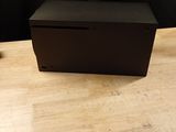 an empty black box sitting on top of a wooden table