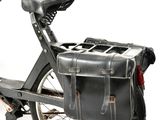 a black bike with a black bag on the back of it
