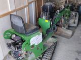 a small green machine that is parked in a garage