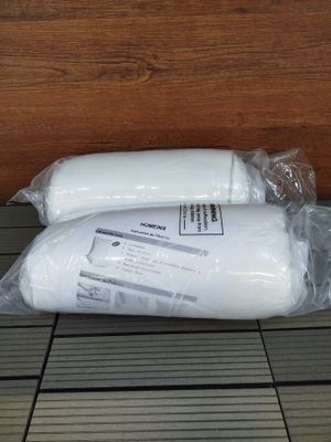 two rolls of toilet paper wrapped in plastic on the floor