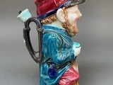 a figurine of a man with a pipe in his hand