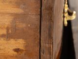a wooden box with a chain hanging from it