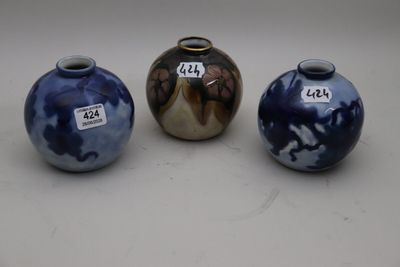 three blue and white vases sitting next to each other on a table