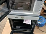 two microwaves that are stacked on top of each other