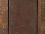 an old picture frame with a sticker on it sitting on a wooden floor