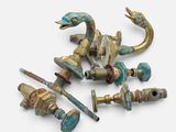 a group of brass and turquoise colored items on a white surface