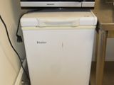 a microwave sitting on top of a refrigerator in a kitchen