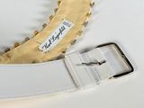 an image of a white belt with gold spikes on it