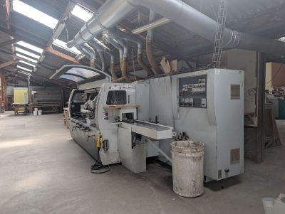 a machine that is working on a piece of wood in a building