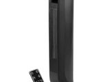 a black tower heater sitting next to a remote control