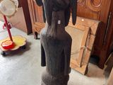 a statue of a woman that is sitting on a stool