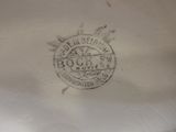 a close up of a vase with a stamp on it