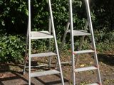 two ladders sitting next to each other on the ground