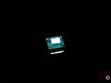 a laptop computer sitting in the dark on a table