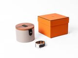 an orange box with a ring and a ring holder on a white surface
