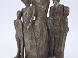 statue of a group of people sitting on top of a rock