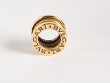 a close up of a gold ring on a white surface
