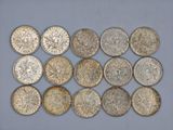a bunch of silver coins sitting on top of a table