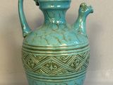 a blue vase that is sitting on a table