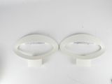 two white bowls on a white table with a spoon and spoon rest