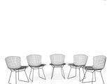 three black wire chairs sitting next to each other on a white surface