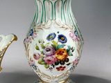 three vases with flowers on them sitting next to each other