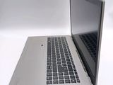 a silver laptop with a black keyboard on a white surface