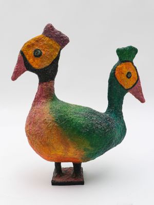 a colorful bird that is standing on a wooden stand