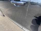 a black cat that is sitting on the side of a car