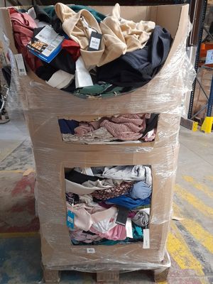 a cart with a lot of clothes on it in a warehouse