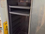 an open refrigerator in the middle of a kitchen