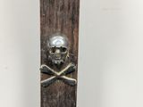 a wooden ski with a skull and crossbones on it