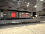 a close up of a clock on the back of a bus