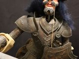 a toy of a man with a sword and a helmet