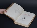 a person holding an open book in their hand