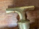 a brass faucet that is sitting on a wooden table