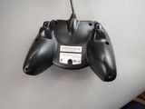 a remote control attached to the back of a laptop
