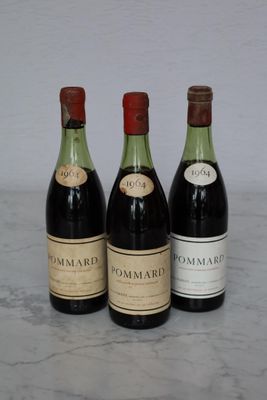 three bottles of wine that are sitting on a table