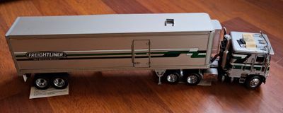 un camion miniature posé sur un plancher en bois