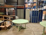 a table and two chairs in a warehouse area