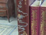 three books that are sitting on a glass table