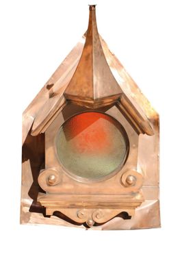 a small clock with a red light inside of it