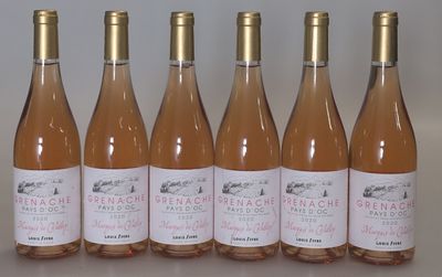 six bottles of pink wine are lined up on a table
