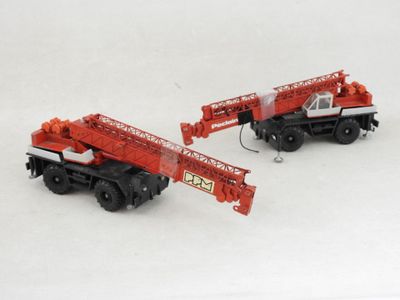 two toy trucks that are sitting next to each other