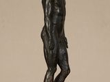 bronze statue of a man standing on a marble base