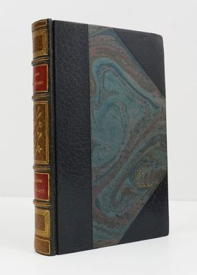 an old book sitting on top of a white table next to a white wall