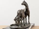 statue of a horse and a cow on a marble base